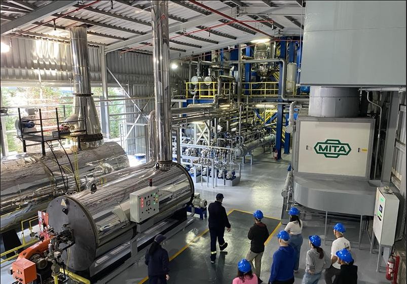 A group of people in a factory AI-generated content may be incorrect.