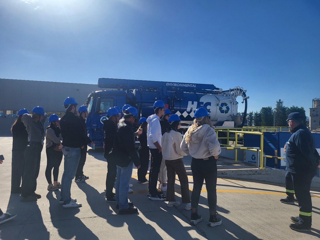 A group of people standing in front of a truck AI-generated content may be incorrect.